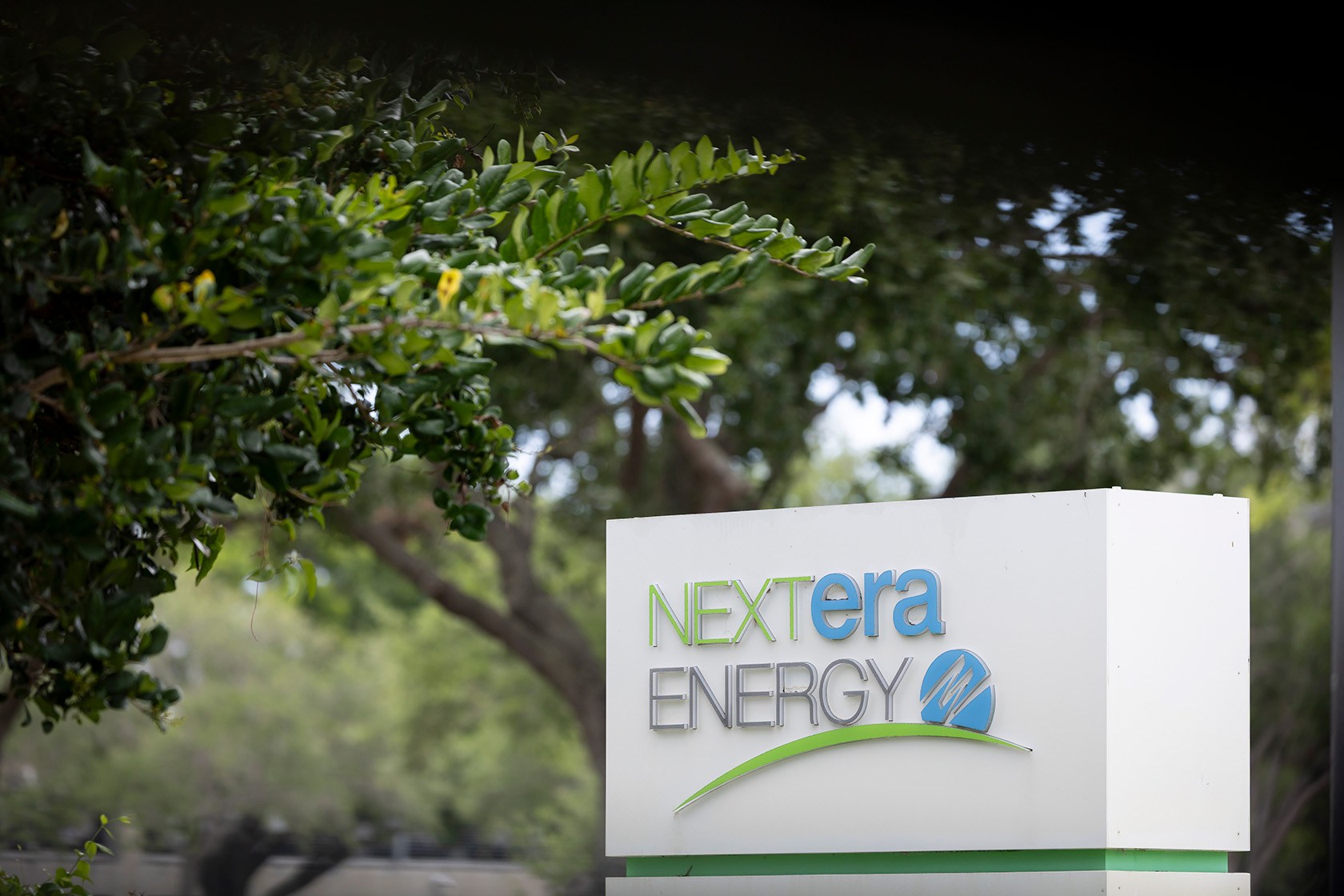 The logo of NextEra Energy is seen at the entrance of its headquarters.